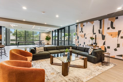 a living room with couches and chairs and a glass table